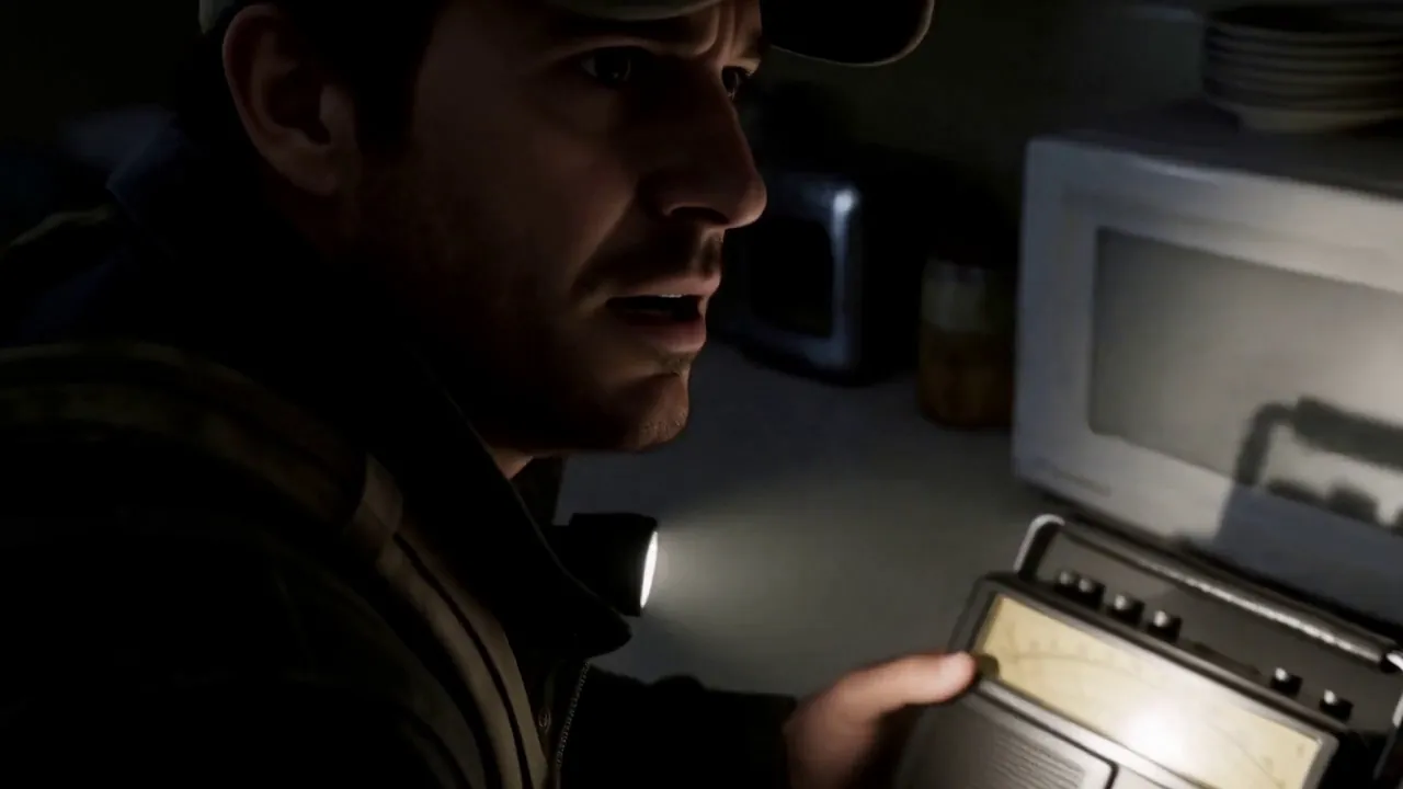A worried man listens to the radio in a dark kitchen